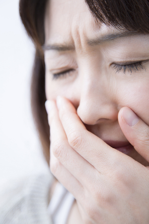 Middle women to suppress the mouthの写真素材
