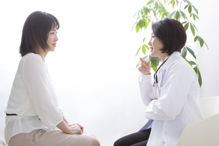 Female doctor and women to the medical examinationの写真素材