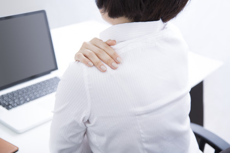 Businesswoman suffer from shoulder stiffnessの写真素材