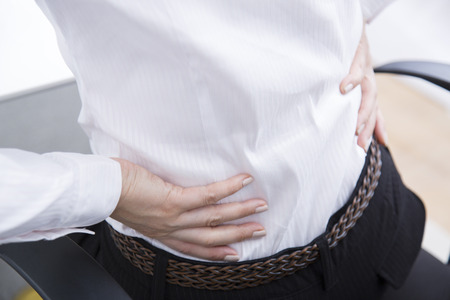 Business woman suffering from low back painの写真素材