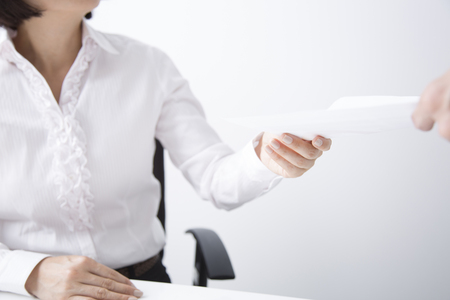 Businesswoman receiving documentsの写真素材
