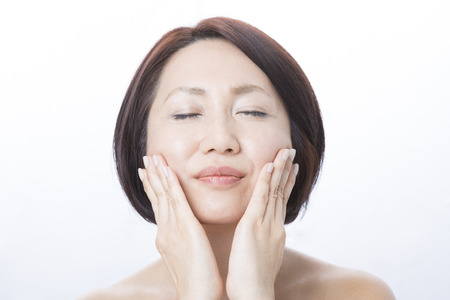 Middle women Hands on both cheeksの写真素材