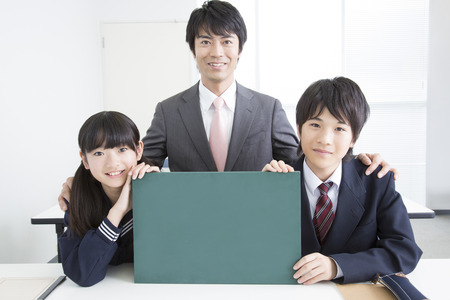 Junior high school students and teachers with a message boardの写真素材