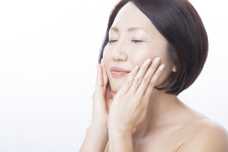 Businesswoman shed hand on the cheekの写真素材