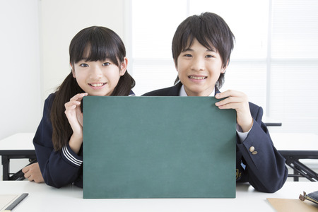 Junior high school students with a message boardの写真素材
