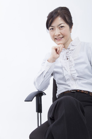 Businesswoman you smile sitting in a chairの写真素材