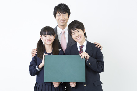 Junior high school students and teachers with a message boardの写真素材