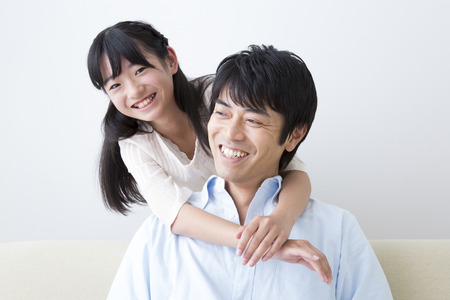 Daughter hugging fatherの写真素材