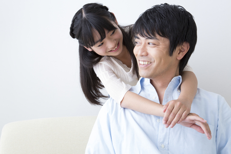 Daughter hugging fatherの写真素材