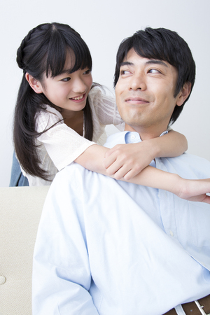 Daughter hugging fatherの写真素材