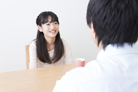 Father and son to a conversation in the diningの写真素材