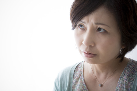 Middle women anxious about somethingの写真素材