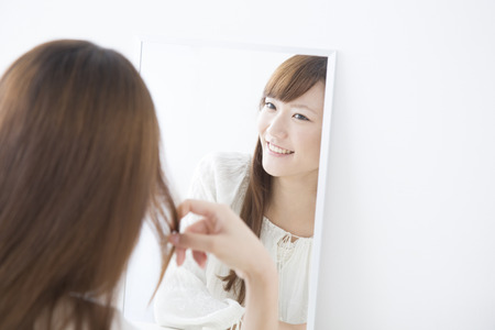 Women smile and look in the mirrorの写真素材