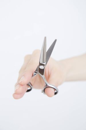 Hand of the hairdresser with scissorsの写真素材