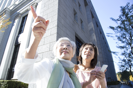 Mother and daughter find a way in the smartphoneの写真素材