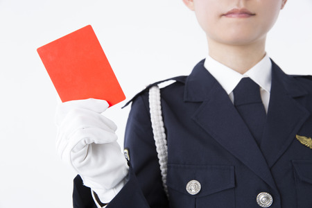 Female police officer with a red cardの写真素材