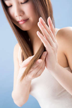 women checking hairの写真素材