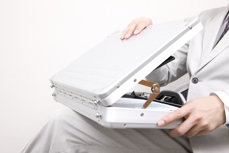 Businessman opening the suitcaseの写真素材