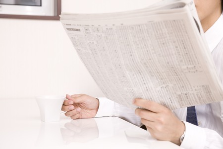 Businessman reading a newspaperの写真素材