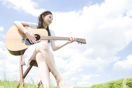 Woman playing the guitarの写真素材