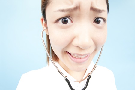 Nurse the examination with a stethoscopeの写真素材