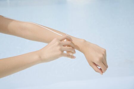 Hand of a woman painting a sunscreenの写真素材