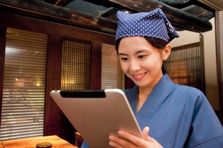 Tavern clerk to see the tablet PCの写真素材