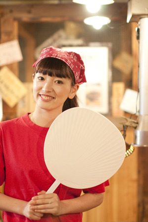 Clerk smiling with a fan