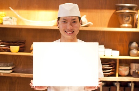 The chef with a message board smilingの写真素材