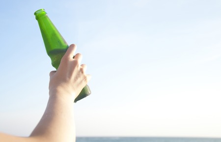 Hand of a woman with a bottle of juiceの写真素材