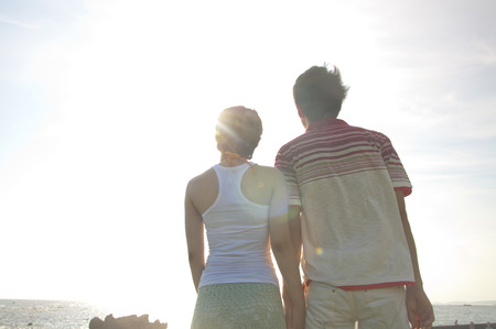 Rear View of a couple that connects the handの写真素材