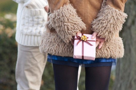 Rear of women hide gifts