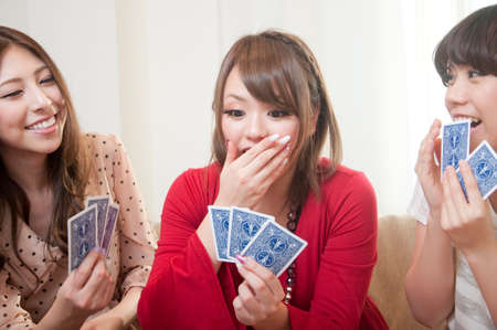 Three women to the card gameの写真素材