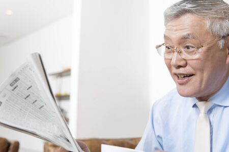Senior man reading newspaperの写真素材