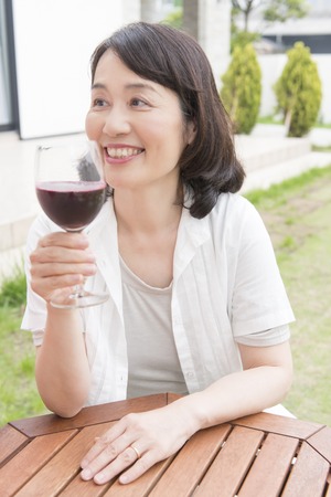 Senior women who drink red wineの写真素材