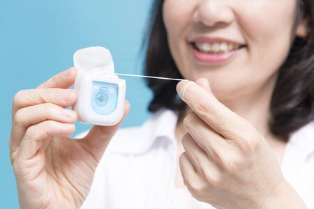 Senior women using dental flossの写真素材