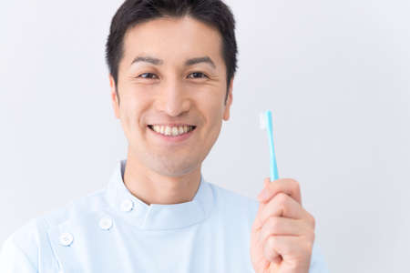 Dentist with a toothbrushの写真素材