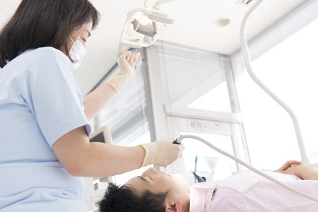 Female dentist and male patientの写真素材