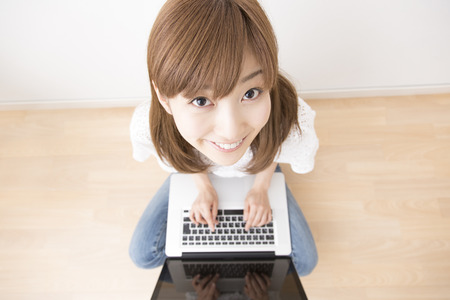 Woman surprised to touch the notebook PCの写真素材