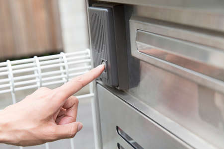 Hand of man to press the chimeの写真素材