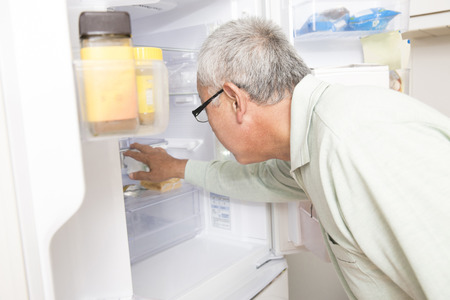 Senior hunts a refrigerator manの写真素材