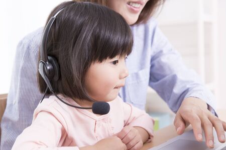 Mother with girl to work with PCの写真素材