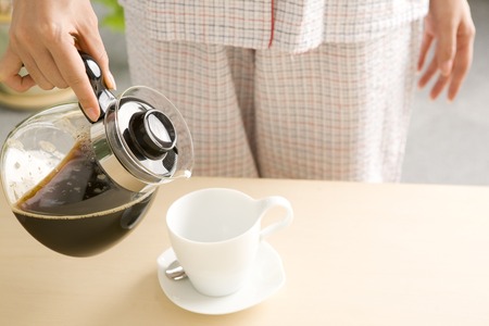 Hand to put the coffeeの写真素材