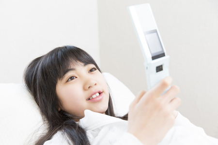 Girl to operate the mobile phoneの写真素材