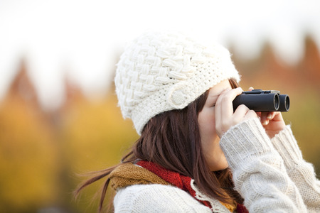Woman overlooking the distant telescopeの写真素材