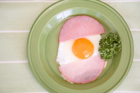 Green dish and ham and eggsの写真素材