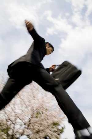 Businessman to run the cherry backの写真素材