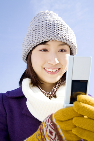 Woman to check e-mail on mobileの写真素材