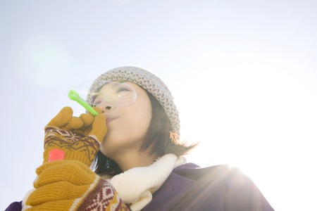 Women play with soap bubbles