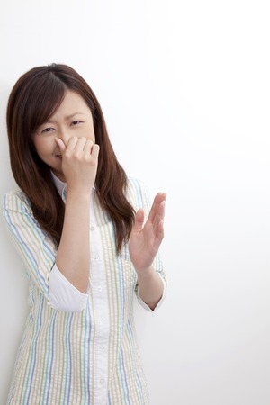 Women pinch the nose to smellの写真素材